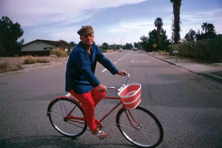 Truman Capote con una bicicleta por Palm Springs