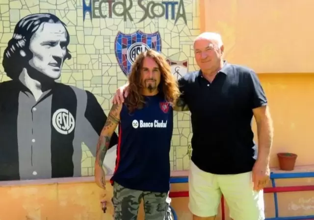 H�ctor Scotta junto al historiador cuervo Victor Pradel, en un mural en la entrada de su casa junto a unos asientos del Viejo Gas�metro.